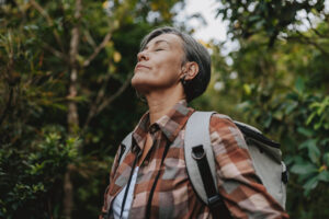 Portrait of a woman breathing in nature