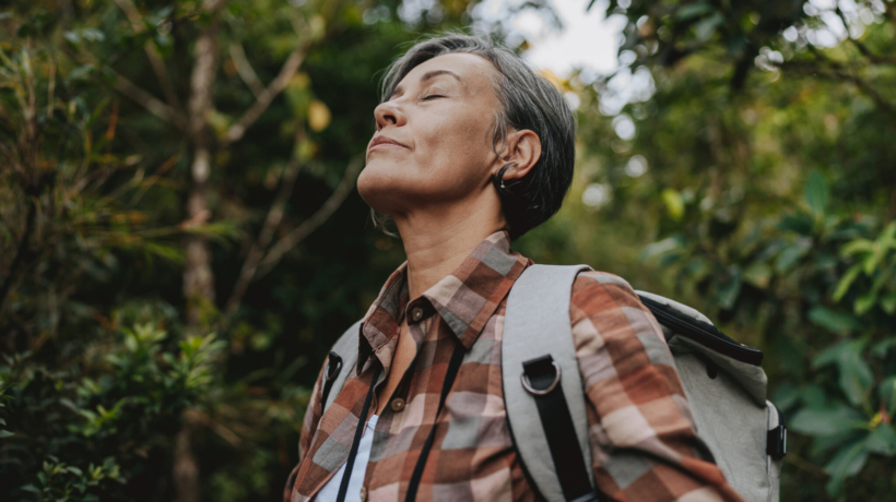 Portrait of a woman breathing in nature